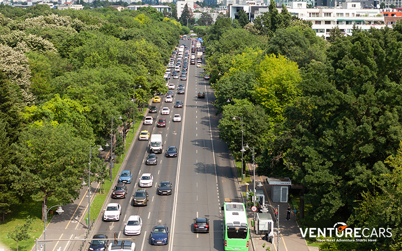 Venture Cars PHV models navigating stop-and-go traffic in Singapore.