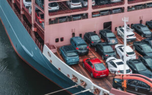 Cargo ship importing vehicles under Singapore car regulations.